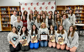 Yearbook staff poses with their award