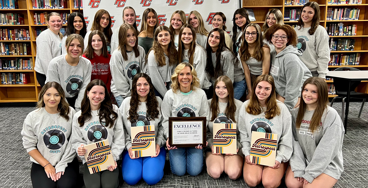 Fort Cherry Yearbook Staff posing for group picture with the yearbook and award.
